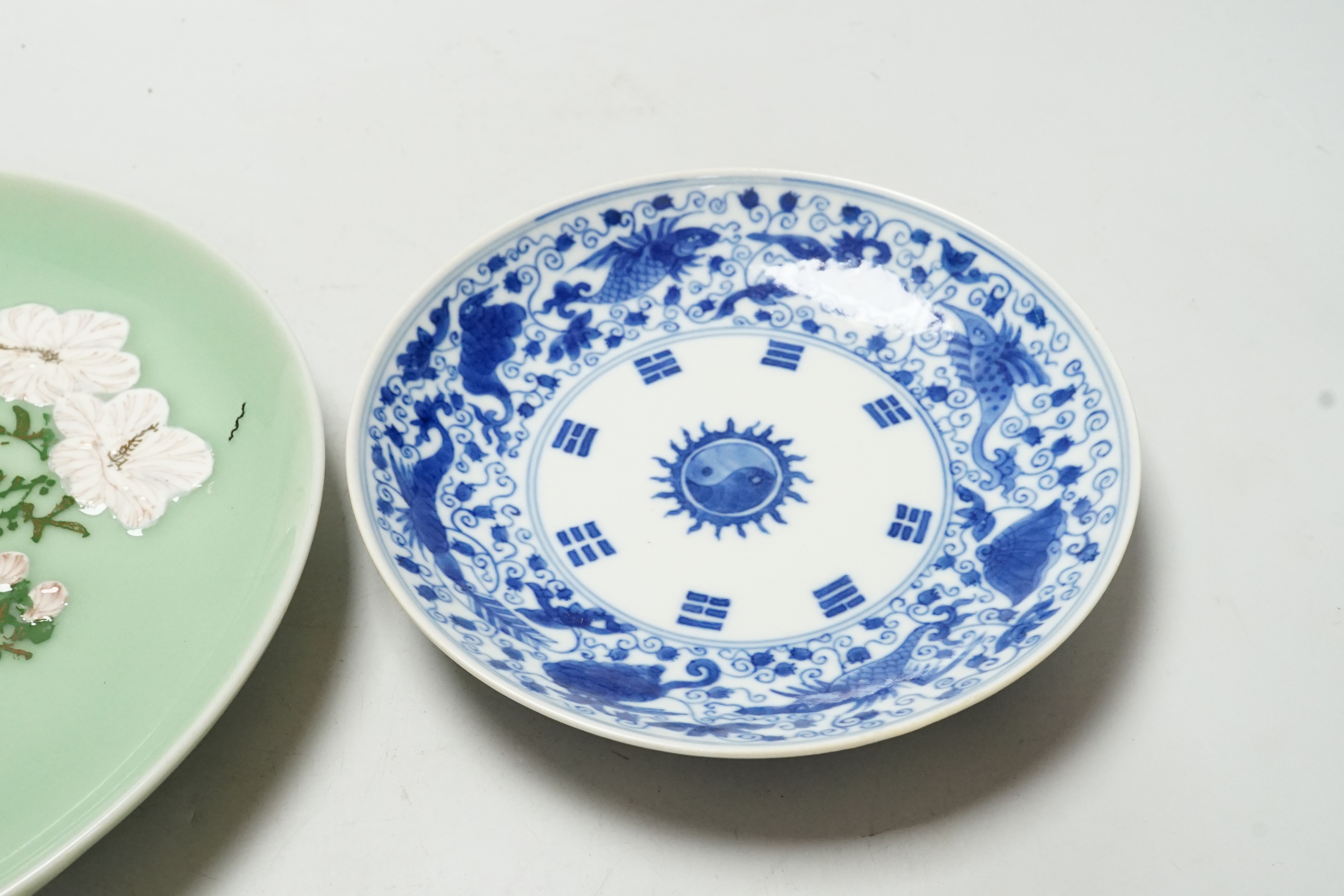 A Japanese celadon ground dish and a Chinese blue and white dish, largest 22cm diameter